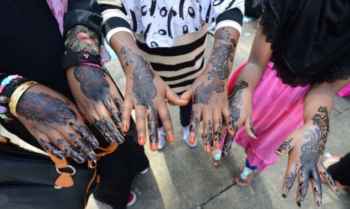 Young Muslim girls show their hands decorated with henna after attending prayers on Eid Al-Fitr at the Regent's Park Mosque in London on August 19, 2012. (Adek Berry - AFP/Getty Images)