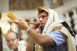 A Tokea (which literally means “blaster”) blows into a shofar in the Conegliano Synagogue in Jerusalem to announce the Jewish New Year, Rosh HaShanah (meaning “head of the year” in Hebrew)